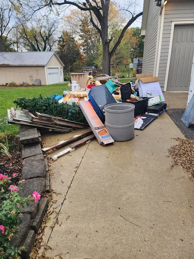 Dumpster being loaded with debris for 30 Yard Dumpster Rental in Paulding